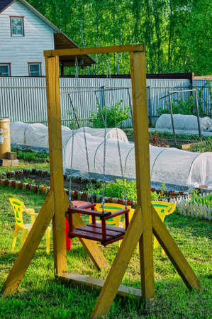 children's wooden swings in the village, springの写真素材