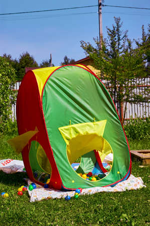 colorful children's tent in the garden, in summerの写真素材