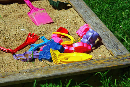 children's plastic toys in the sandbox, in summer
