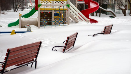 childrens playground after heavy snowfallの写真素材