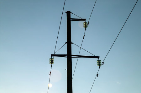 pole with high-voltage electrical wires, in summer