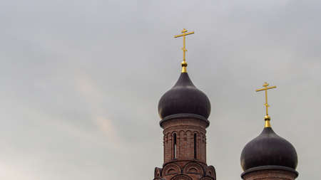 crosses on the domes of the Orthodox Church, against the background of the cloudy sky