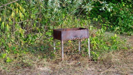old barbecue is abandoned on the bank of the river, in summerの写真素材