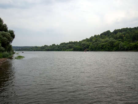 river bank on a cloudy day, in summer