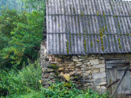 old stone barn in the village, in summerの写真素材