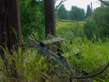 a collapsed wooden pedestrian bridge over the river, in summerの写真素材