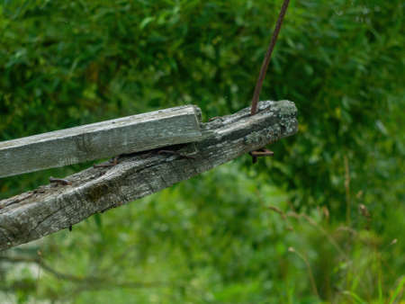 a collapsed wooden pedestrian bridge over the river, in summerの写真素材