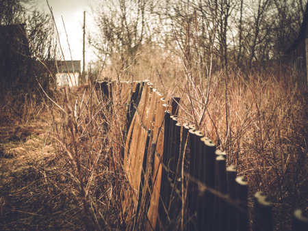 Old fence in the village of Russia in springの写真素材