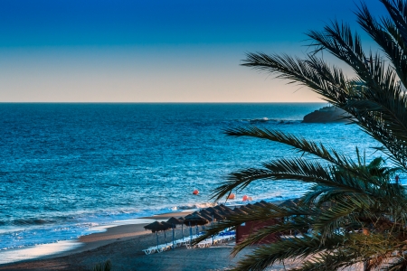 Beach landscape with sun loungers in the eveningの写真素材