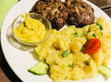 Meatballs with mustard potato salad and bread