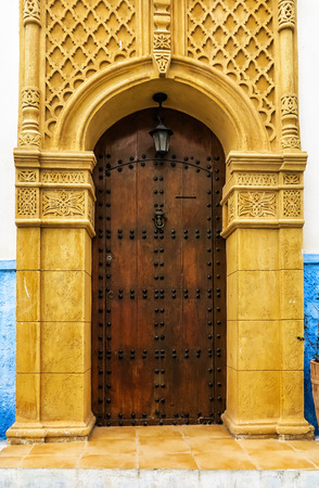Ancient Moroccan art craftsmanship - Brown Door with nail ornamentのeditorial素材