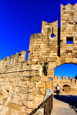 Ancient city wall with entrance to the harbor in Rhodes Town, Greeceの写真素材