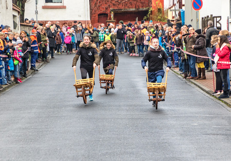 BRUCHKOEBEL, GERMANY-JANUARY 22, 2018: An original fun contest ? ? "Traditional annual event ? ?" Wheelbarrow raceのeditorial素材