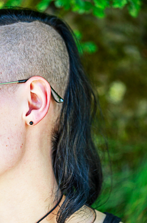 A young man with half shaved head hairstyleの写真素材