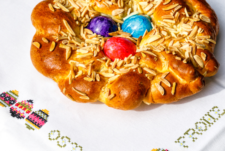 Homemade easter traditional bread decorated with colorful eggs, festive bakeryの写真素材