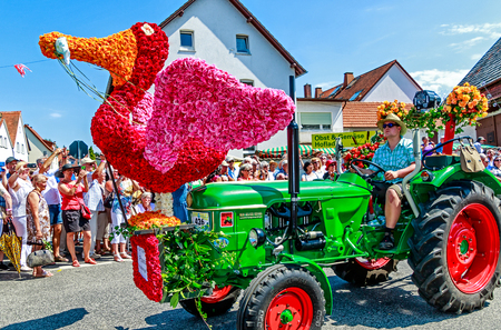 STEINFURTH, GERMANY-JULY 15, 2018 Giant bird made of countless rose petals on a parade carriage. Germany's "Rose Village" Steinfurth celebrates 150 years of rose cultivation with a large parade.のeditorial素材