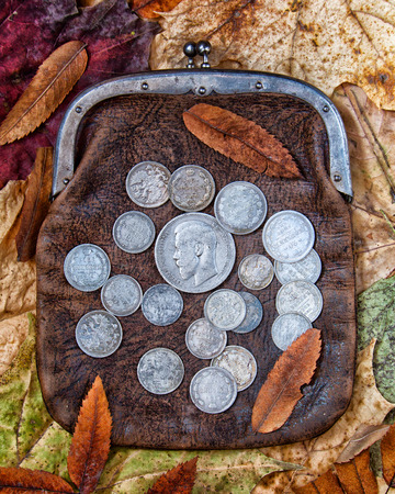 Old leather purse with silver coins of tsars of House of Romanovs of 19-20 centuries.の写真素材