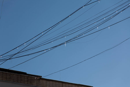 chaos electric wires, thrown from roof to roofの写真素材