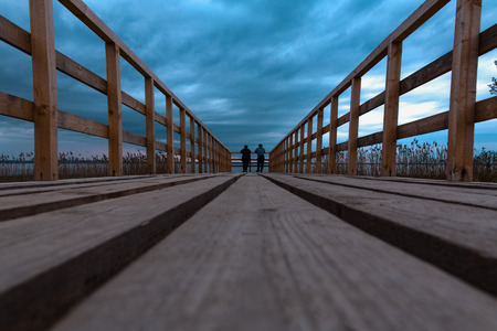 the wooden bridge in one party before the coming nearer thunder stormの写真素材