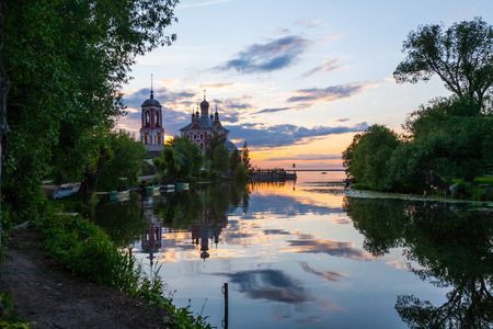 the mouth of the river in the summer evening against a decline and Christian churchの写真素材