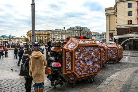 Moscow, Russia - October 14, 2015: Moscow Kremlin and Red Square. The entrance on Red Square has a brisk trade in souvenirs - fur and military caps, wooden nested dolls.のeditorial素材