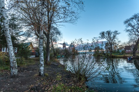 the mouth of the river in the summer evening against a decline and Christian churchの写真素材
