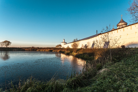 Pereslavl-Zalessky, Russia - October 21, 2015: Nikitsky Monastery, is founded in 1010.  Fragment of a monastic wall and monastic pond in the first ice.のeditorial素材