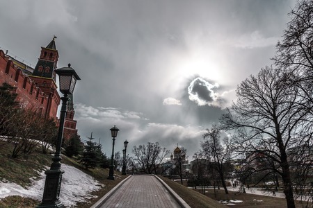 Moscow, Russia - March 20, 2016: View of the Kremlin wall from a walking path against the sun in a haze.のeditorial素材
