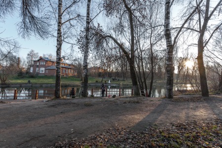 In the quiet autumn evening on the river bank fishermen catch fish, newlyweds are photographed for memory. Idyll.の写真素材