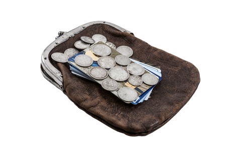 silver Russian coins of the 19th century against credit cards and an ancient purse