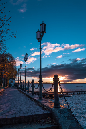In a few minutes the sun at sunset will leave for the horizon and night lamps that the late fishermen reached the houses will be lit.の写真素材
