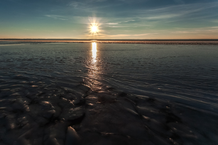 The unexpected hard frost froze waves in the lake in the movement.の写真素材