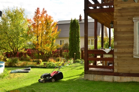 Mow the lawn, prepare the pool for winter storage, collect fallen leaves and remove from the annual flower beds - concern summer cottage garden before the winter season の写真素材