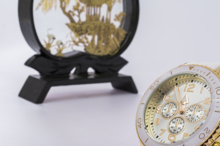 Women's white watch and Japanese figurine. five minutes to twelveの写真素材