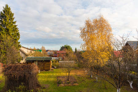 Autumn garden in front of a country houseの写真素材