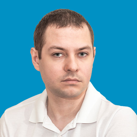 Portrait of a young man in a white T-shirt on a blue backgroundの写真素材
