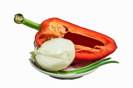 Red peppers, onions and green onions on a small saucer. Isolateの写真素材