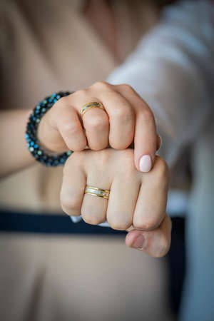Hands of the bride and groom with engagement rings, clenched in fistsの写真素材
