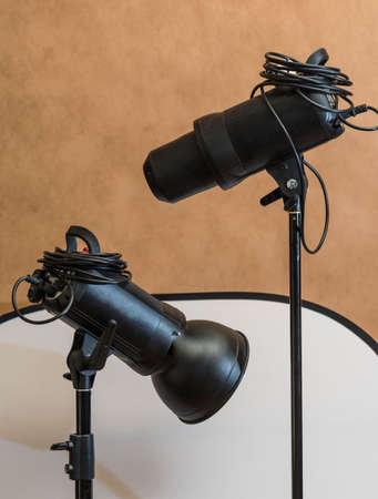 Photo studio equipment - two flashes on stands, background and full-length white reflectorの写真素材