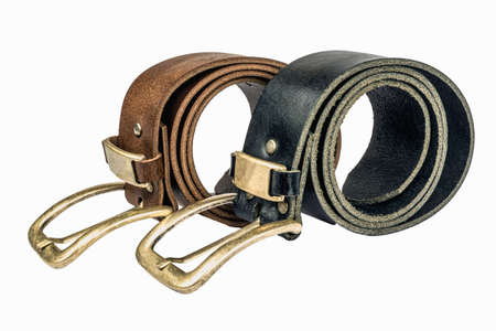 Two men's leather belt, black and brown on a table on a white backgroundの写真素材