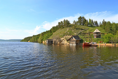 View from the river to the mountain and lakeside housesの写真素材
