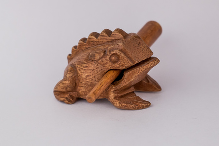 Wooden figurine on a white background, Frog with stickの写真素材