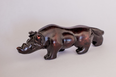 Wooden figurine on a white background, black rhinocerosの写真素材