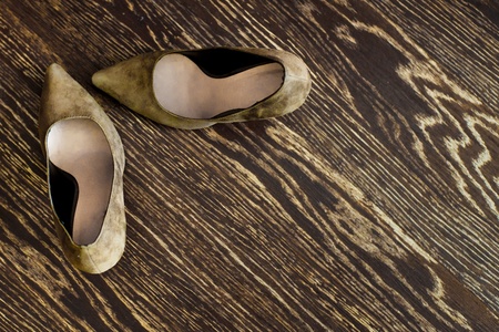 Two women's shoes stand on the wooden floorの写真素材