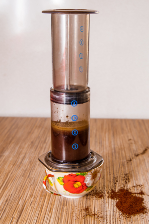Preparation of ground coffee in aeropress - portable filter coffee makerの写真素材