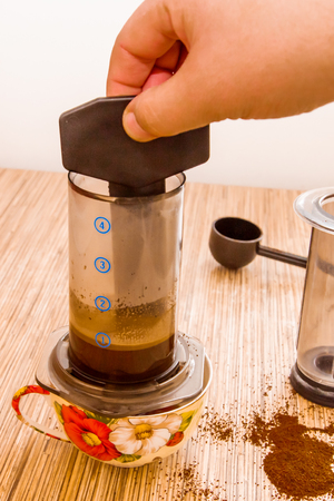 Preparation of ground coffee in aeropress - portable filter coffee makerの写真素材