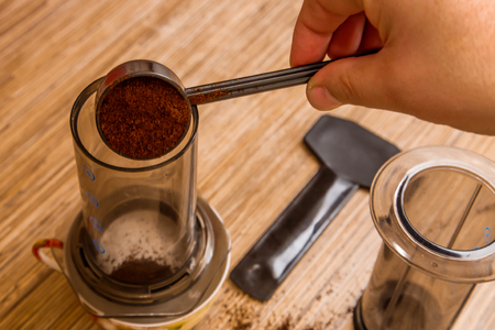 Preparation of ground coffee in aeropress - portable filter coffee makerの写真素材