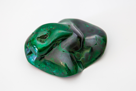 Gemstone green malachite lies on white backgroundの写真素材