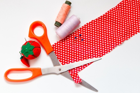 Sewing composition - a piece of cloth, scissors, thread, needles