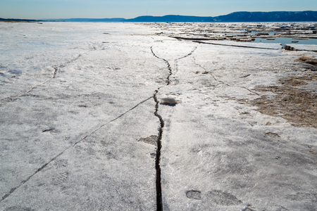 Spring melting of ice on the Volga River against the background of mountains and blue skyの写真素材
